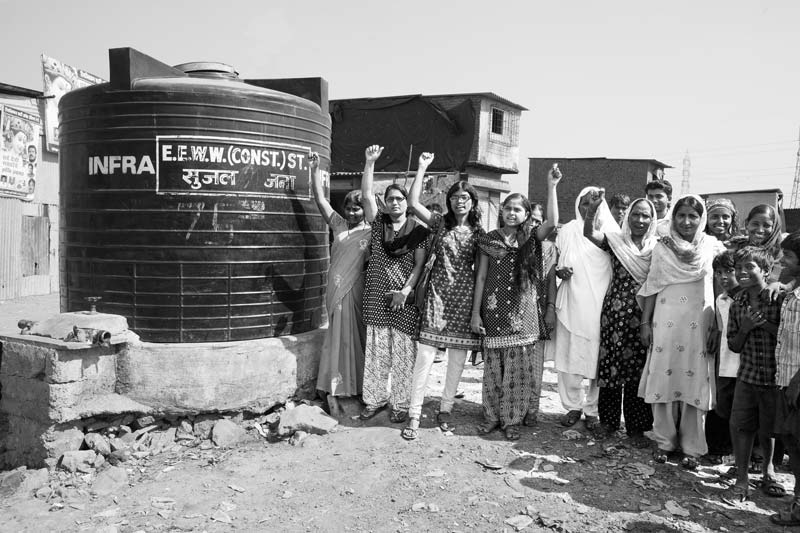 Women protesting to secure their human right to water near a government-installed water tank in an informal settlement in Mumbai, Maharashtra